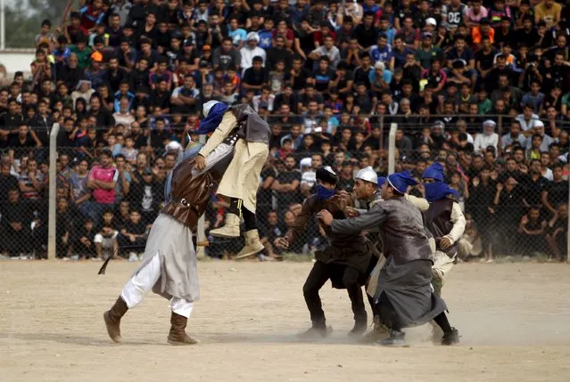 Local actors dressed as ancient warriors re-enact a scene from the 7th century battle of Kerbala during commemoration in Sadr City, Baghdad, October 24, 2015. (Photo by Ahmed Saad/Reuters)