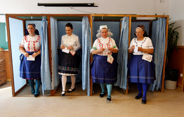 Hungarian women wearing traditional costume leave a voting booth at a polling station during a referendum on EU migrant quotas in Veresegyhaz, Hungary, October 2, 2016. (Photo by Bernadett Szabo/Reuters)