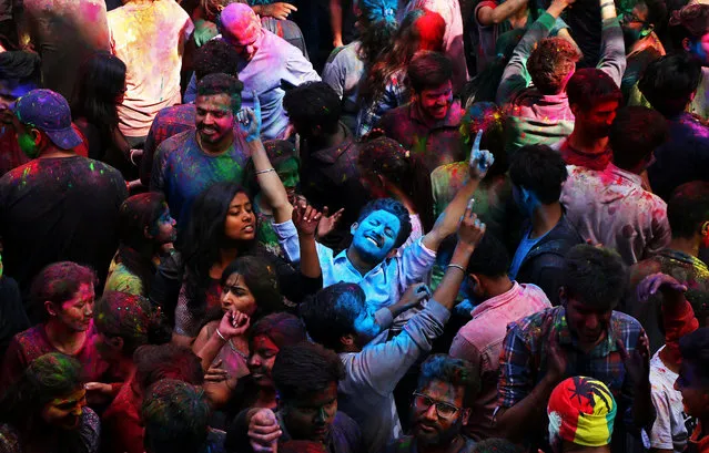 Students with their faces smeared in coloured powder dance as they celebrate Holi at a university campus in Chandigarh, India on March 2, 2018. (Photo by Ajay Verma/Reuters)