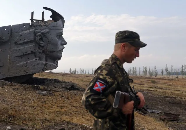 A Pro-Russian separatist stands near the damaged war memorial at Savur-Mohyla, a hill east of the city of Donetsk, in this August 28, 2014 file photo. (Photo by Maxim Shemetov/Reuters)