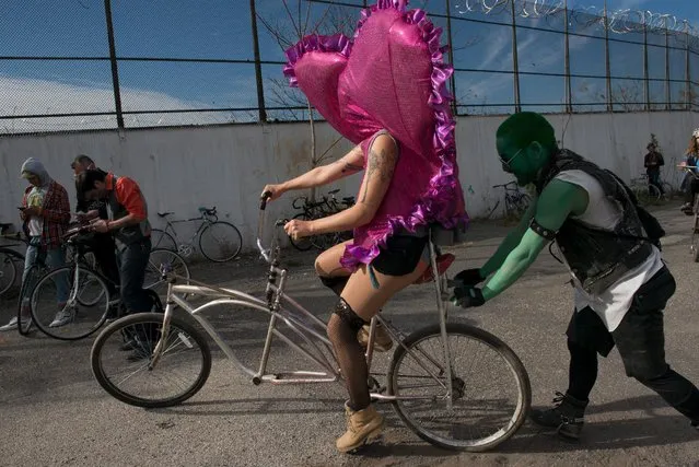 A woman rides a custom bike during "Bike Kill 12" in the Brooklyn borough of New York City, October 31, 2015. (Photo by Stephanie Keith/Reuters)