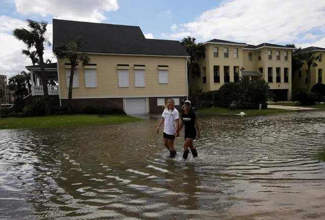 People walk through flooded streets after Hurricane Matthew hit, In Jacksonville Beach, Florida, U.S., October 8, 2016. (Photo by Henry Romero/Reuters)
