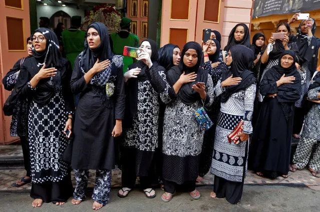 Shi'ite muslim women mourn as they watch a Muharram procession in Ahmedabad, India, October 10, 2016. (Photo by Amit Dave/Reuters)