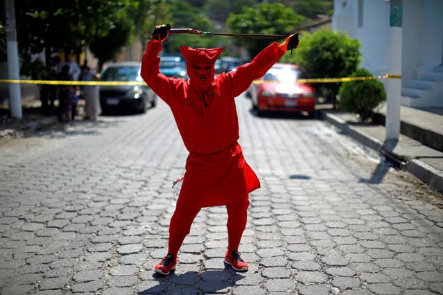 A man dressed as a demon poses for a picture as he participates in a ceremony known as Los Talciguines, as part of religious activities to mark the start of the Holy Week in Texistepeque, El Salvador, March 26, 2018. (Photo by Jose Cabezas/Reuters)