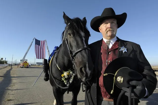 Deputy Hill Goedhart leads the riderless horse Max that belonged to Lancaster sheriff's Deputy Steve Owen before a memorial service on Thursday, October 13, 2016 in Lancaster, Calif. Owen, a 29-year sheriff's veteran, was shot on Oct. 5 as he answered a report of a burglary at an apartment building in the city north of Los Angeles. (Photo by John McCoy/Los Angeles Daily News via AP Photo)