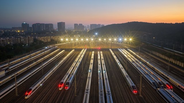Aerial view of bullet trains waiting on storage tracks at Nanjing South Railway Station on October 10, 2025 in Nanjing, Jiangsu Province of China. National railways began implementing a new train operation map on October 11, and arranged to operate more than 13,000 passenger trains. (Photo by Fang Dongxu/VCG via Getty Images)