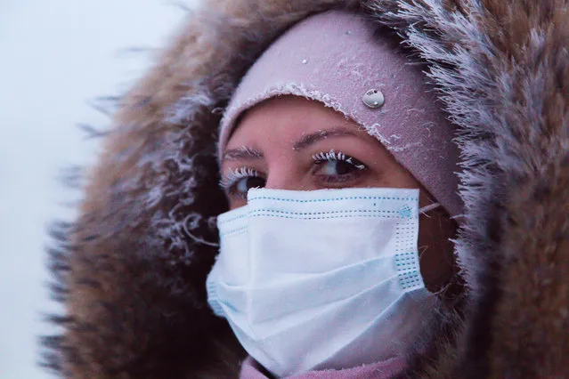 A woman wears a face mask outside in freezing conditions of minus 43 degrees Celsius in the city of Yakutsk, Sakha (Yakutia), Russia on December 13, 2020. The lowest temperature recorded in Yakutsk was -64.4C, in February 1891. (Photo by Yevgeny Sofroneyev/TASS)