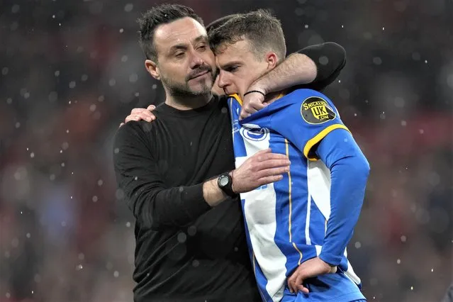 Brighton's head coach Roberto De Zerbi comforts Brighton's Solly March after the English FA Cup semifinal soccer match between Brighton and Hove Albion and Manchester United at Wembley Stadium in London, Sunday, April 23, 2023. (Photo by Kirsty Wigglesworth/AP Photo)