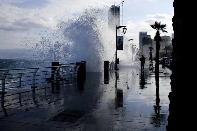 A Lebanese man runs as waves crash on the seafront at the Corniche, or waterfront promenade, in Beirut, Lebanon, Wednesday, November 2, 2016. (Photo by Hassan Ammar/AP Photo)