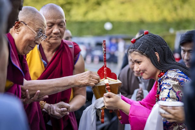Tibetan spiritual leader, the Dalai Lama, Tenzin Gyatso (L) is welcomed by Tibetans living in Switzerland upon his arrival at a Hotel in Opfikon, outside Zurich, Switzerland, 23 August 2024. The Dalai Lama visits Switzerland from 23 to 26 August to speak in Zurich's Hallenstadion on 25 August. (Photo by Michael Buholzer/EPA/EFE)