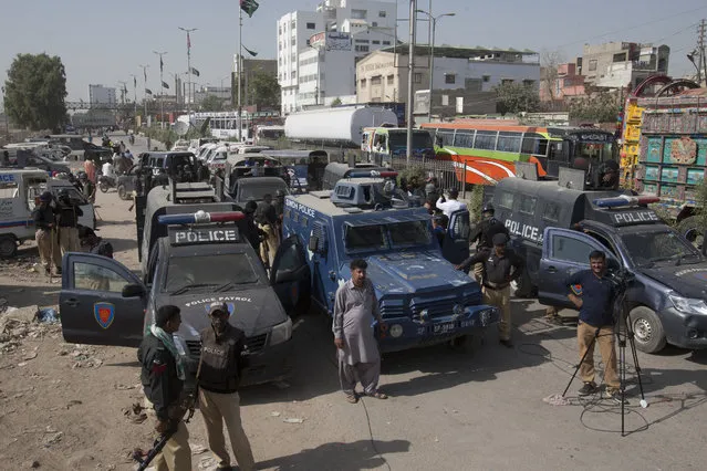 Pakistani security forces and ambulances standby at the site of a protest in Karachi, Pakistan, Monday, November 7, 2016. A Pakistani counter-terrorism police officer says several Sunni and Shiite Muslim leaders have been detained in a probe over recent sectarian attacks in the southern port city of Karachi. (Photo by Shakil Adil/AP Photo)