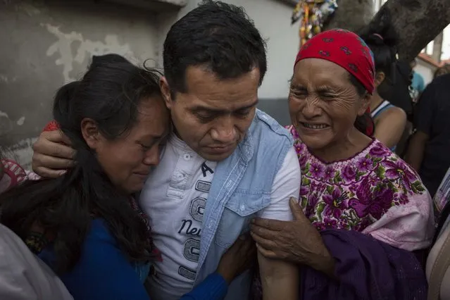 Deported from the United States Juan Lopez is embraced by family members after his arrival at the Air Force Base in Guatemala City, Wednesday, June 20, 2018. Lopez was among around 250 deported illegal migrants who arrived in Guatemala City on two chartered flights paid for by U.S. taxpayers. (Photo by Luis Soto/AP Photo)