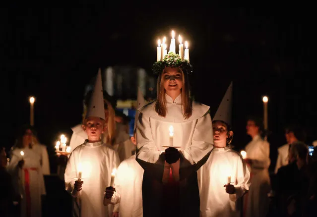 Sara Kjorling, 24, from Stockholm leads the procession during the traditional Swedish festival of Sankta Lucia at York Minster on December 11, 2015 in York, England. The festival of Sankta Lucia is a traditional Swedish festival of light that celebrates the bringer of light during the long darkness of winter. The service features a candlelit procession and carols in celebration of St Lucy, a young Sicilian girl who was martyred for her Christian faith in the early fourth century. (Photo by Ian Forsyth/Getty Images)