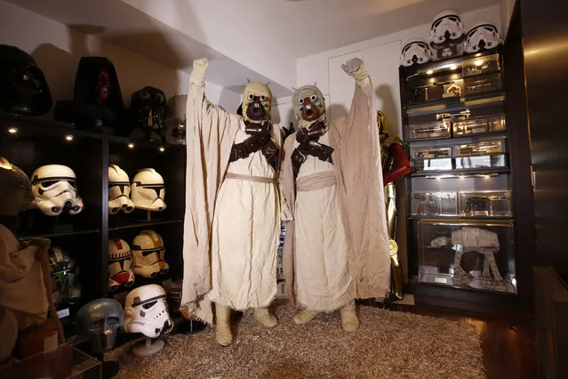 Star Wars fans Yusuke Yamana, 41, (R) and his wife Anna, 33, from Minnesota, in the U.S., pose for a photo while dressed as Tusken Raiders in front of Star Wars memorabilia at their home in Yokohama, south of Tokyo, Japan November 23, 2015. Yusuke and Anna met at a Star Wars fan event in Japan in 2011 and got married in 2015. (Photo by Issei Kato/Reuters)