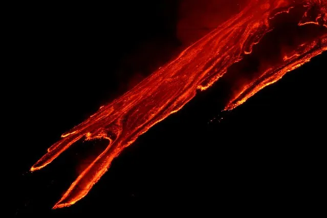 Streams of red hot lava flow as Mount Etna, Europe's most active volcano, leaps into action, seen from Zafferana Etnea, Italy, February 21, 2021. (Photo by Antonio Parrinello/Reuters)