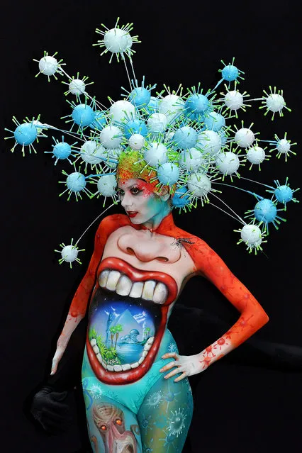 A participant poses with her body paintings designed by bodypainting artist Peter Tronser during the 16th World Bodypainting Festival in Poertschach on July 6, 2013 in Poertschach am Woerthersee, Austria. (Photo by Didier Messens/Getty Images)