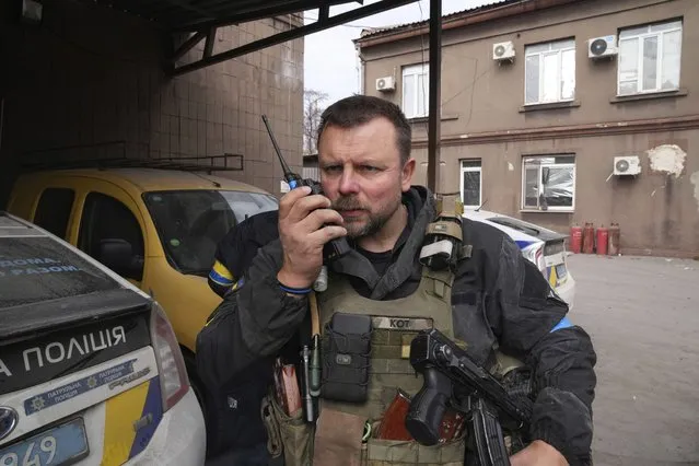 Mikhailo Vershinin, head of Mariupol's Police Patrol speaks by a radio on his base in Mariupol, Ukraine, Tuesday, March 15, 2022. The Mariupol police officer who was among the last defenders to surrender from the Azovstal steel mill is among those to mark a year since they surrendered on orders of the Ukrainian president. The group are treated as heroes across Ukraine for drawing Russian forces away from the attack elsewhere in the country and for changing the course of the war. (Photo by Evgeniy Maloletka/AP Photo)