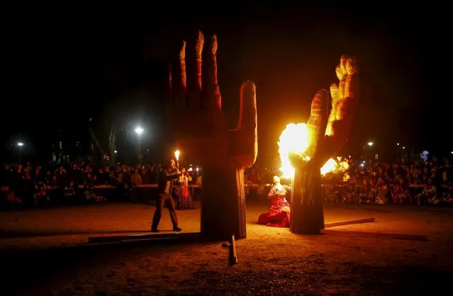 Revellers take part in the 26th Annual Kensington Market Winter Solstice Parade as they burn a giant hand structure in Toronto, December 21, 2015. (Photo by Mark Blinch/Reuters)