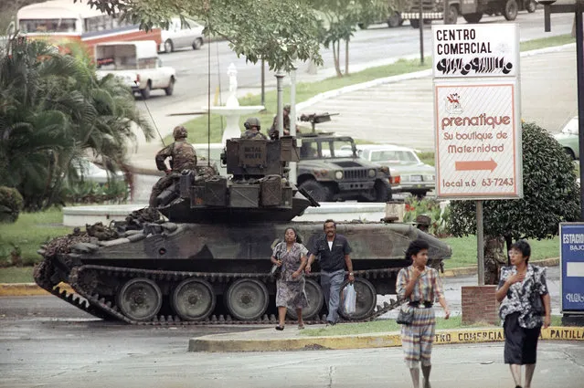 A U.S. Army tank forms a roadblock off a traffic circle leading to the Vatican Embassy in Panama City on Wednesday, December 27, 1989 where Manuel Noriega has sought asylum. (Photo by Roberto Borea/AP Photo)