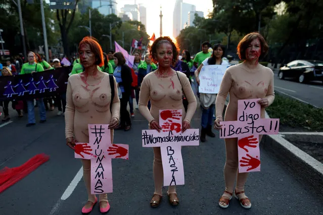 Women hold placards during a demonstration to commemorate the U.N. International Day for the Elimination of Violence against Women in Mexico City, Mexico, November 25, 2016. The crosses read (L-R) “Not one more”, “No More Femicide, enough”, “I say enough”. (Photo by Carlos Jasso/Reuters)