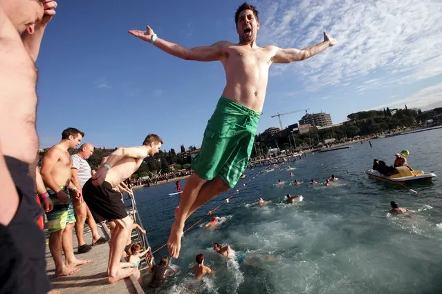 Participants take part in a New Year's Jump into the Sea in Portoroz , Slovenia, January 1, 2016. (Photo by Srdjan Zivulovic/Reuters)