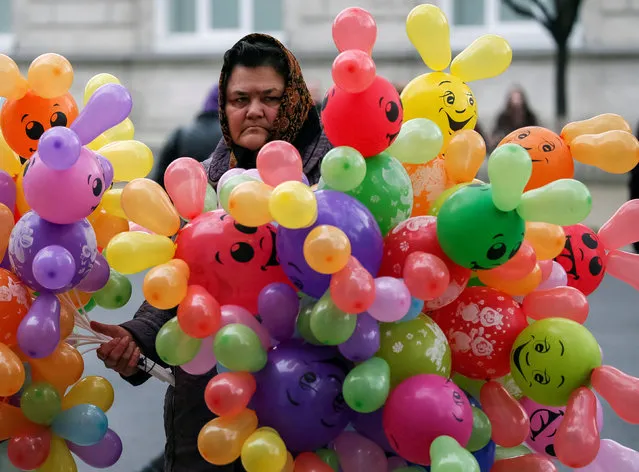 A woman sells balloons on the street in central Chisinau, Moldova, November 12, 2016. (Photo by Gleb Garanich/Reuters)