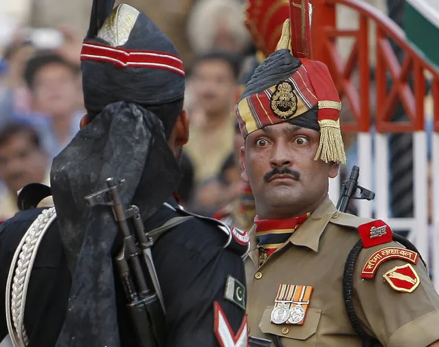 In this July 19, 2009 file photo, an Indian Border Security Force soldier, right, and a Pakistani Rangers soldier face one another at a daily closing ceremony at the Wagah border post near Lahore, Pakistan. India has called off a planned meeting between its foreign minister and her Pakistani counterpart on the sidelines of the U.N. General Assembly session in New York this month, aggravating tensions between the longtime rivals. Foreign Ministry spokesman Raveesh Kumar said Friday, September 21, 2018, that India's decision to pull out of the meeting, which had been announced a day earlier, follows the killing of an Indian border guard in Kashmir and Pakistan's glorification of insurgents fighting Indian rule in the Himalayan territory. (Photo by Vincent Thian/AP Photo)
