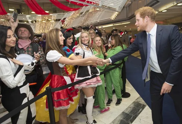 Britain's Prince Harry greets a well wisher as he takes part in a charity trading day at ICAP in support of his charity Sentebale, in London, December 7, 2016. (Photo by Geoff Pugh/Reuters)