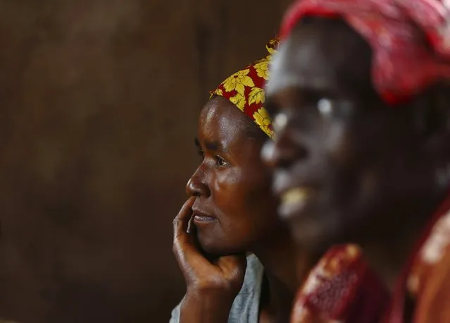 HIV-positive members of a self-help group meet with a caregiver in the village of Michelo, south of the Chikuni Mission in the south of Zambia February 23, 2015. (Photo by Darrin Zammit Lupi/Reuters)