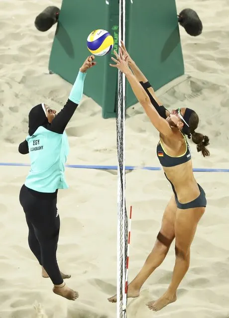 Doaa Elghobashy of Egypt and Kira Walkenhorst of Germany compete in the preliminary beach volleyball event at the Rio Olympics August 7, 2016. (Photo by Lucy Nicholson/Reuters)
