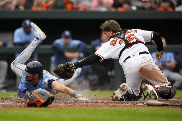 Baltimore Orioles catcher Adley Rutschman (35) tags out Tampa Bay Rays' Josh Lowe in the ninth inning of a baseball game, Sunday, September 17, 2023, in Baltimore. The Orioles won 5-4 in 11 innings to clinch a playoff spot. (Photo by Julio Cortez/AP Photo)