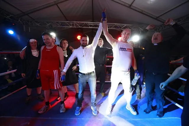 Fr Pierre Pepper (2nd R) reacts after defeating Jared Madden (2nd L) during his amateur boxing match in the town of Banagher  in County Offaly March 15 , 2015. (Photo by Cathal McNaughton/Reuters)