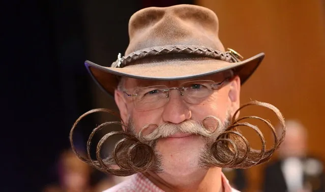 Participant Dieter Besuch from Germany poses after winning the Partial Beard Freestyle category during the World Beard Championships on November 2, 2013 in Leinfelden-Echterdingen, southern Germany. More than 200 competitors from over 20 countries took part in the event. (Photo by Franziska Kraufmann/AFP Photo/DPA)