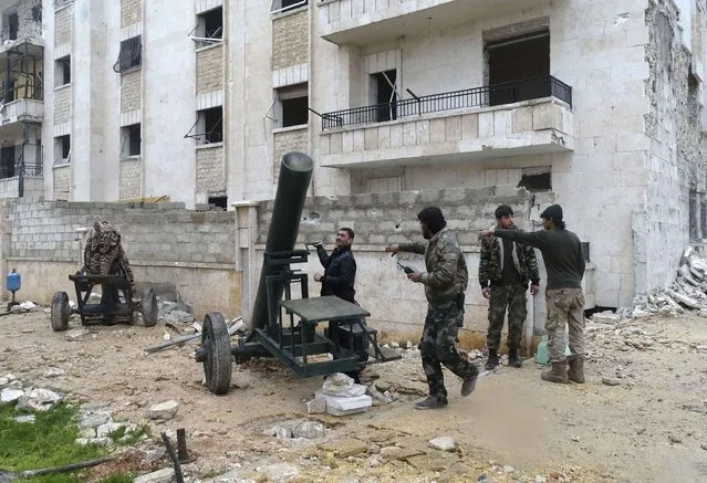 Rebel fighters prepare a mortar at al-Breij frontline, after what they said was an advance by them in al-Manasher and al-Majbal areas where forces loyal to Syria's President Bashar al-Assad were stationed, in Aleppo January 5, 2015. Picture taken January 5, 2015. (Photo by Abdalghne Karoof/Reuters)