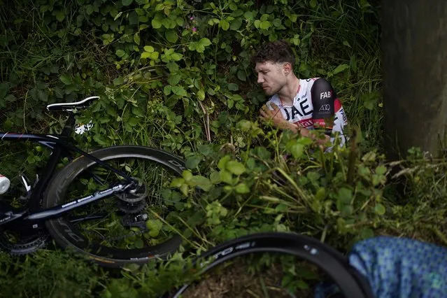 Switzerland's Marc Hirschi lays on the side of the road after crashing during the first stage of the Tour de France cycling race over 197.8 kilometers (122.9 miles) with start in Brest and finish in Landerneau, France, Saturday, June 26, 2021. (Photo by Daniel Cole/AP Photo)