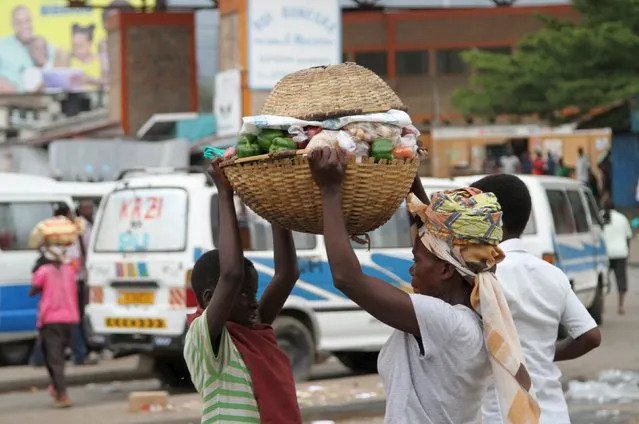 Vendors carry away their grocery after a grenade attack of Burundi's capital Bujumbura, February 3, 2016. (Photo by Jean Pierre Aime Harerimama/Reuters)