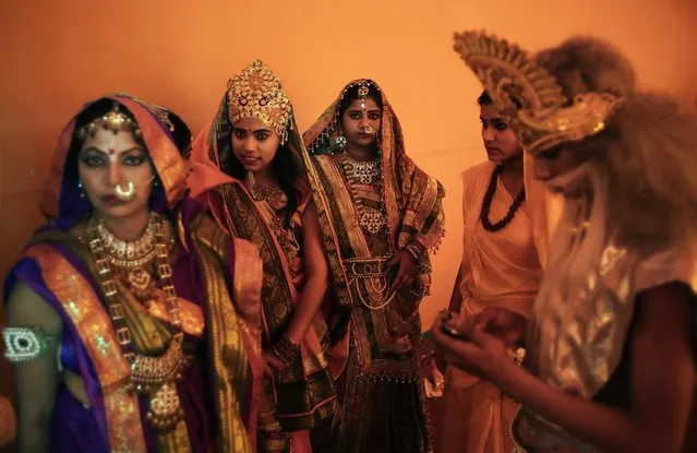 Hindus dressed in the likeness of mythological characters wait to participate in a religious procession on Ram Navami festival in New Delhi, India, Saturday, March 28, 2015. (Photo by Altaf Qadri/AP Photo)