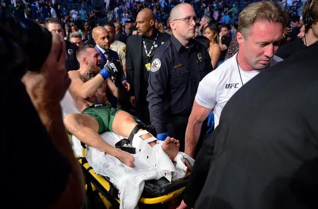 Conor McGregor of Ireland is carried out of the arena on a stretcher after injuring his ankle in the first round of his lightweight bout against Dustin Poirier during UFC 264: Poirier v McGregor 3 at T-Mobile Arena on July 10, 2021 in Las Vegas, Nevada. (Photo by Gary A. Vasquez/USA TODAY Sports)