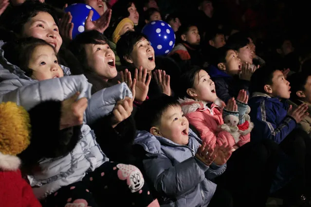 North Koreans react as they gather to watch a New Year's fireworks display at the Kim Il Sung Square in Pyongyang, North Korea, on Sunday, January 1, 2017. (Photo by Kim Kwang Hyon/AP Photo)
