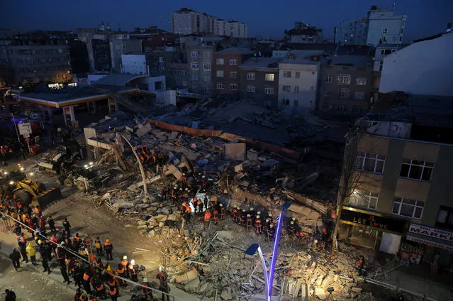 Firemen and rescue workers stand on the wreckage of a building that collapsed and caused several casualities, according to local media, in Istanbul, Turkey, January 13, 2017. (Photo by Huseyin Aldemir/Reuters)