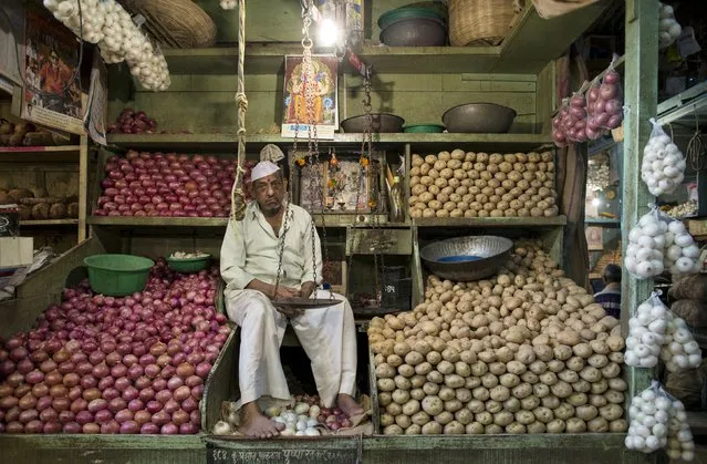 A vendor waits for customers at his stall at a wholesale vegetable and fruit market in Mumbai April 14, 2015. (Photo by Danish Siddiqui/Reuters)