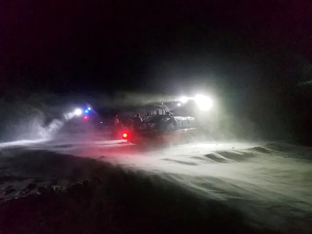 U.S. Coast Guard Station Sturgeon Bay and Department of Natural Resources crews direct seven stranded ice fishermen into airboats, in polar vortex weather system temperatures of minus 4 degrees Fahrenheit (-20 C) with a wind chill factor of minus 30 degrees (-34 C) near Sturgeon Bay, Wisconsin, U.S. January 29, 2019. Picture taken January 29, 2019. (Photo by U.S. Coast Guard/DNR officer Jordan Resop/Handout via Reuters)