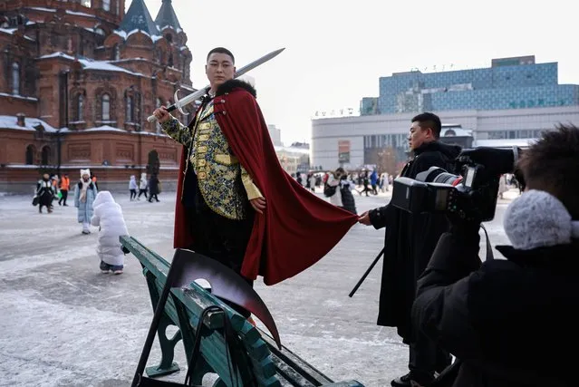 A man wearing a costume poses for pictures during a photo shooting session, in front of the Saint Sophia Cathedral in Harbin, Heilongjiang province, China on January 5, 2024. (Photo by Tingshu Wang/Reuters)