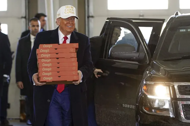 Republican presidential candidate former President Donald Trump delivers pizzas to fire fighters at Waukee Fire Department in Waukee, Iowa, Sunday, January 14, 2024. (Photo by Andrew Harnik/AP Photo)