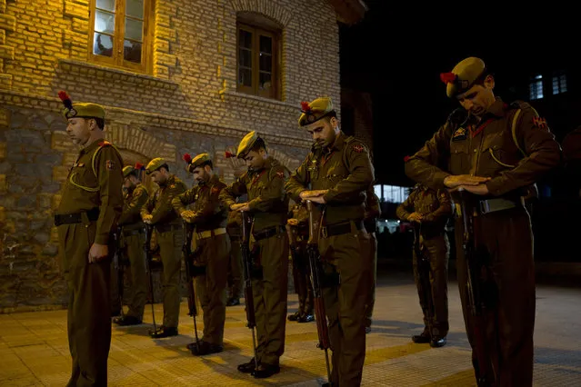 Indian policemen pay homage during a wreath-laying ceremony of their colleague in Srinagar, Indian controlled Kashmir, Monday, Februatu 18, 2019. Tensions escalated in the aftermath of a suicide attack in disputed Kashmir, with nine people killed Monday in a gunbattle that broke out as Indian soldiers scoured the area for militants. (Photo by Dar Yasin/AP Photo)