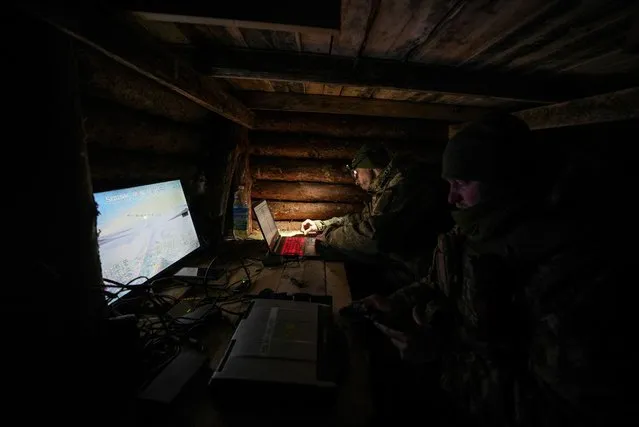 Ukrainian service members of the aerial reconnaissance unit of 45th Separate Artillery Brigade operate a Mara reconnaissance unmanned aerial vehicle from a dugout near the town of Lyman in Donetsk region, Ukraine on January 29, 2024. (Photo by Inna Varenytsia/Reuters)