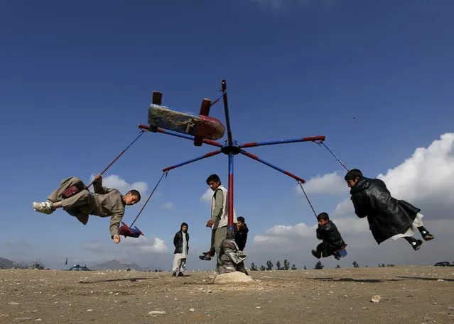 Afghan boys play on a merry-go-round during celebrations for the Afghan New Year, known as Newroz in Kabul, Afghanistan March 20, 2016. (Photo by Mohammad Ismail/Reuters)