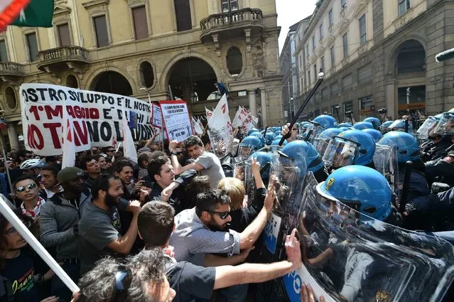 Demonstrators confront police officers as scuffles broke out during a May Day rally in Turin, Italy, Wednesday, May 1, 2019. (Photo by Alessandro Di Marco/ANSA via AP Photo)