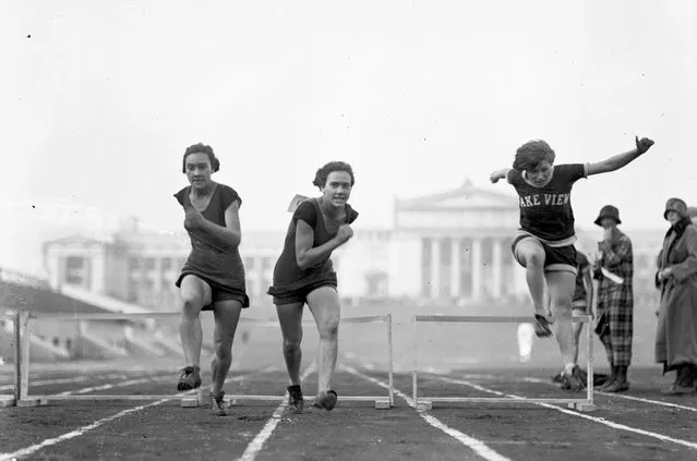 Lake View women athletes Zilk, Sheffield and Sheffield running and jumping over hurdles on a track, Chicago, Illinois, 1924. (Photo by Chicago Sun-Times/Chicago Daily News collection/Chicago History Museum/Getty Images)