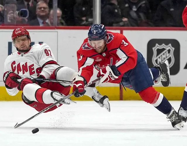 Carolina Hurricanes center Evgeny Kuznetsov, left, and Washington Capitals defenseman Nick Jensen, right, collide as they go for the puck in the first period of an NHL hockey game Friday, March 22, 2024, in Washington. (Photo by Alex Brandon/AP Photo)